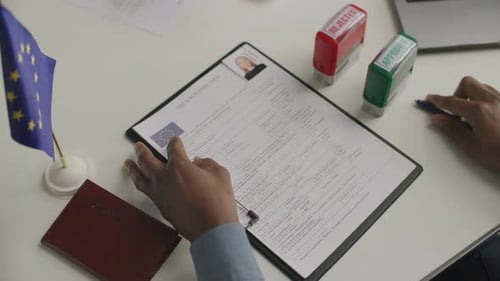 Close-Up of Consular Officer Stamping Approval on European Visa Application
