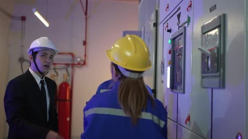 Electrical Workers Consulting at Industrial Control Panel