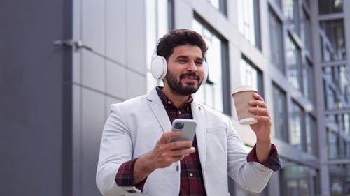 Man Smiling, Listening to Music, Drinking Coffee