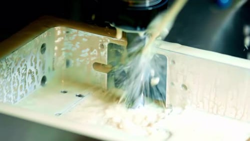 Precision Metal Cutting by CNC with Coolant Flowing in Workshop