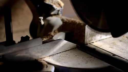 mitre saw sawing wood with power tool in a factory stock footage