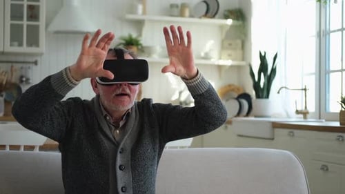 Senior Man Enjoys Virtual Reality Headset at Home