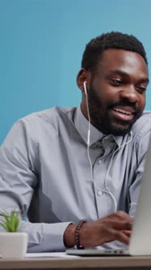 Man Uses Laptop in Office Setting