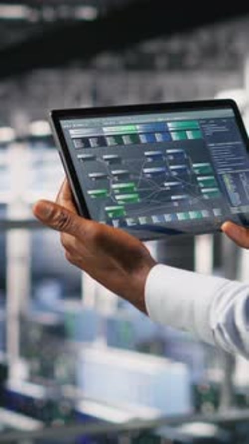 Vertical Video Data Center Admin Checking Code on Tablet Next to Colleague