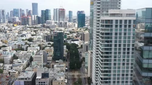 Aerial Shot Of Downtown District In Residential City, Drone Flying Forward Over Cars Moving On Road