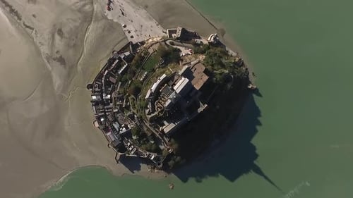 Mont Saint Michel island during low tide, Normandy in France. Aerial top-down ascending