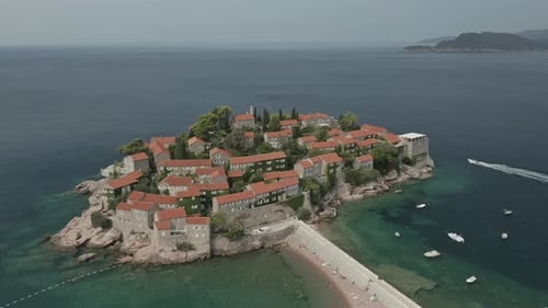 Establishing drone shot approaching Sveti Stefan Island in Montenegro.