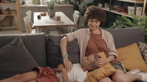 Woman and Girl Relaxing on Couch in Living Room