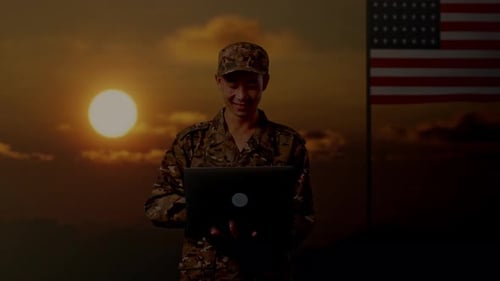 Asian Man Soldier Using A Laptop With Flag Of The United States