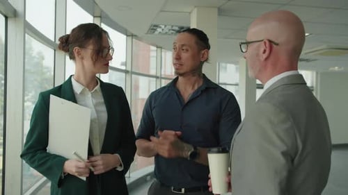 Three Diverse Office Employees Talking during Coffee Break at Office