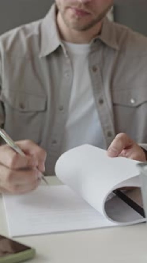 Adult Signing Paperwork in Workplace