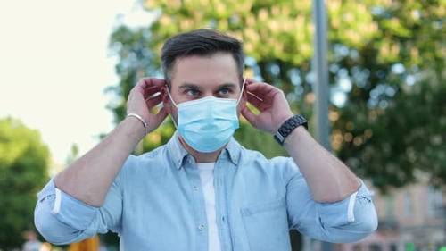 Close Up of Young Caucasian Man Wearing Medical Mask on Face and Looking at Camera Beautiful Male