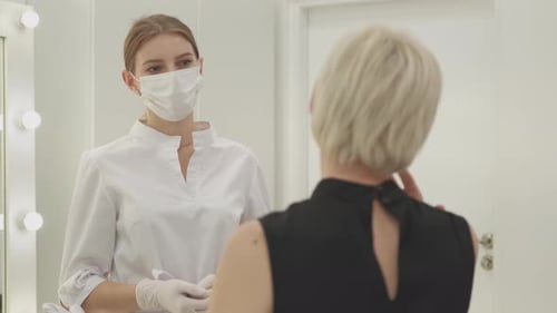 Health Professional Consulting With Patient in Medical Office