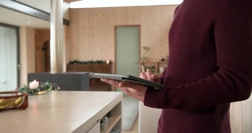 Man Using Tablet to Control Smart Home System