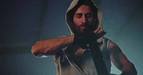 Male Athlete Wraps Hands in Gym for Boxing