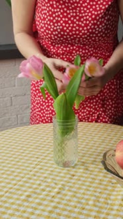 Vertical Video Woman Places a Bouquet of Spring Tulips in a Vase