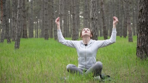 Spiritual Woman Meditating in Forest on Grass Mindful Female Practicing Meditation on Grass in Woods