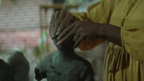 Woman Sculpting Clay Bust in Studio Close Up