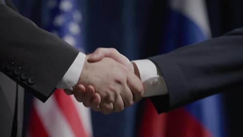 Close-Up of Political Leaders Shaking Hands at Global Press Conference