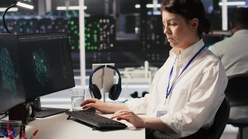 Data Center Technician Monitoring Server Rigs Performing AI Training