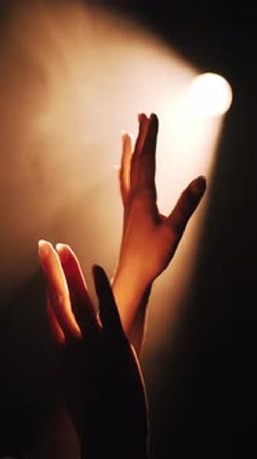 Hand Reaching for Light in the Darkness