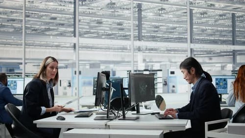 Professional Diverse Engineers Working in a Modern High-Tech Industrial Office