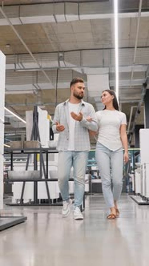Young Couple Choosing Bathroom Fixtures in a Hardware Store