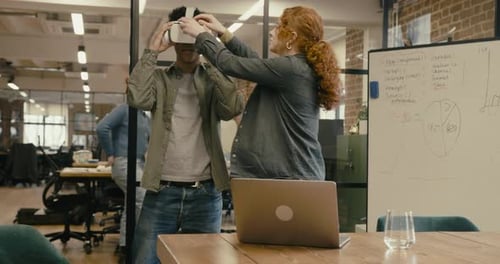 Young Adult Technology Engineers Using Virtual Reality in Office, using VR headset