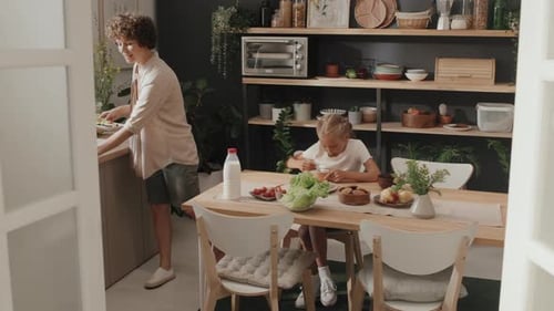 Young Adult and Child Eating a Meal