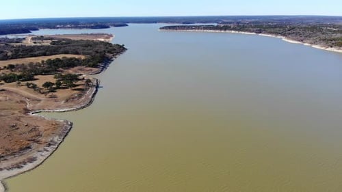 Drone Shot Beginning High Above the Lake Framing One Third of the Water Below
