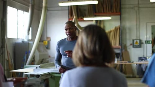 Black Instructor Teaching Carpentry Class in Workshop