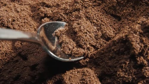 Spoon take freshly ground coffee. Brew smelling morning coffee