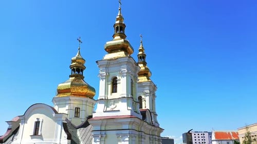 Gorgeous tops of orthodox cathedral with golden cupolas. Christian church at backdrop of blue sky