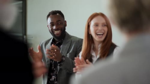 Smiling Business People Clapping in Modern Office