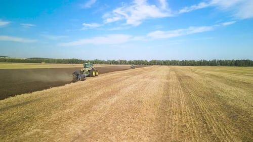 Tractors plowing the field in Ukraine