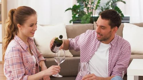 Smiling Couple Pours Red Wine in Sunny Home