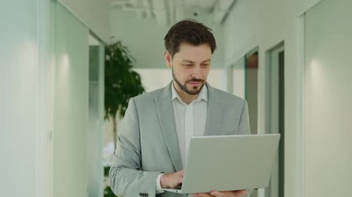 Handsome It Worker Entrepreneur Standing in Office Holding Laptop Typing on Keyboard