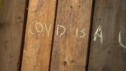 Street art graffiti, message of conspiracy theory of Covid-19 virus during Coronavirus pandemic lock