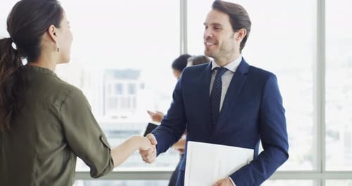 Business People Shaking Hands in a Modern Workplace