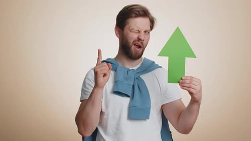 Man Holding Green Arrow Pointing Upward