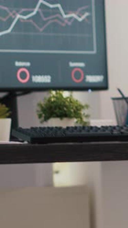 Vertical Video Wheelchair in Inclusive Office and Business Forecasting Graphs on Laptop