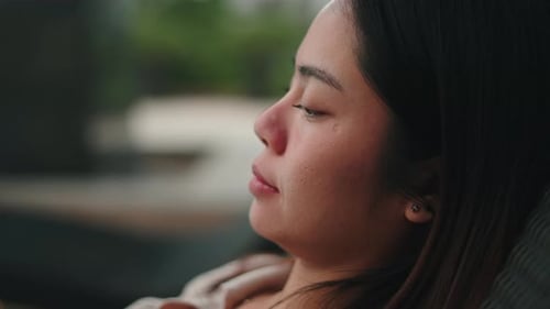 Woman Relaxing with Eyes Closed in Home