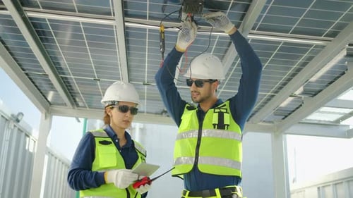 Solar Panel Technicians Inspecting Renewable Energy Installation