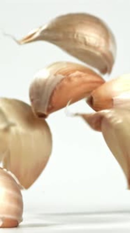 Fresh Garlic Falls on the Table Filmed on a Highspeed Camera at 1000 Fps