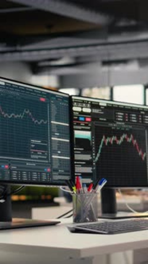 Vertical Video Computer Screens Displaying Stock Market Charts in Proprietary Firm Office