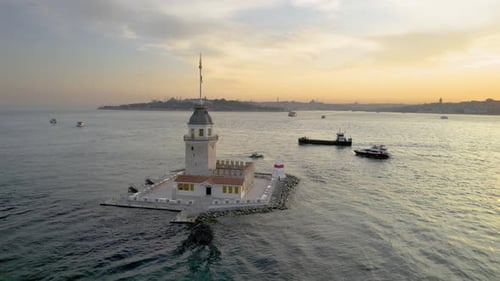 4k Sunset Aerial view of Kiz Kulesi in Istanbul, with boats and ships moving on the Bosphorus strait