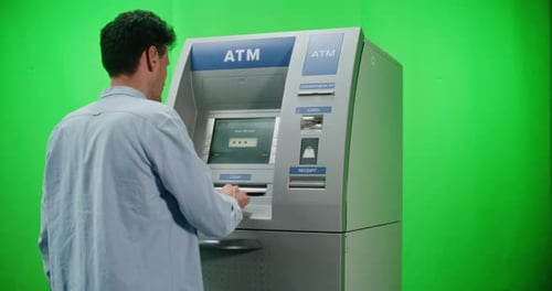 ATM Machine on Green Chroma Key Background Man Performing Cash Withdrawal