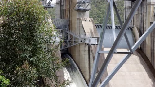 Zoomed shot of a small side valve which lets some water escape the massive dam.