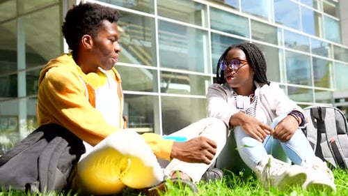 African Students Having Fun Sitting on the Grass at Campus