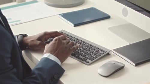 Man Typing on Keyboard in Modern Office